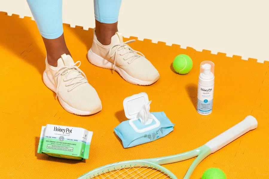 A collection of Honey Pot products surrounded by tennis equipment.